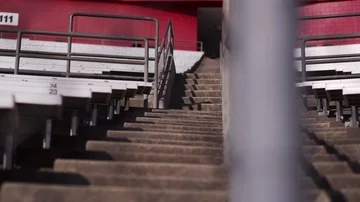 Slow motion slider shot along aisle of empty football stands Stock Footage 85579508