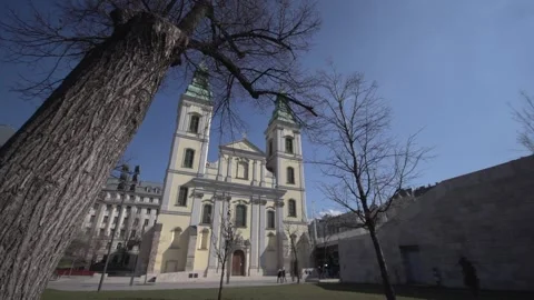 Slow Motion Slider Shot of Historic Church Framed by Bare Trees Stock Footage 336063603