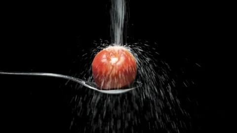 Slow motion slow motion of sugar falling on apple on black background Stock Footage 131406342