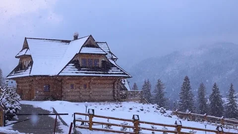 Slow motion. slowly falling snow on background of a beautiful village house Stock Footage 194428169