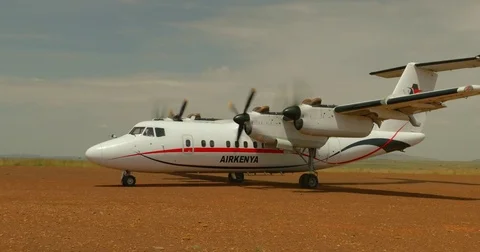 Slow motion of small Air Kenya aircraft landing at Keekorok airstrip in Maasai Stock Footage 81560059