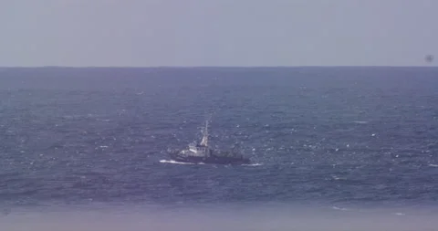 Slow motion of small cargo ship travelling across ocean water surface calmly Stock Footage 156118898
