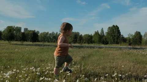 Slow motion of a Small child running through the Park. Stock Footage 110820817