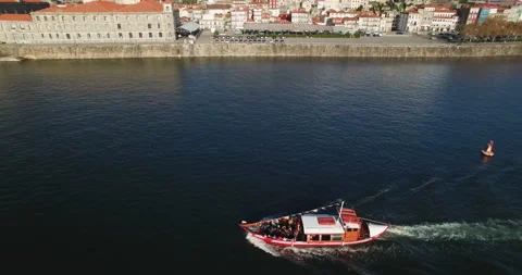 Slow motion of small cruise ship travelling across broad Douro river in Porto Stock Footage 155248577