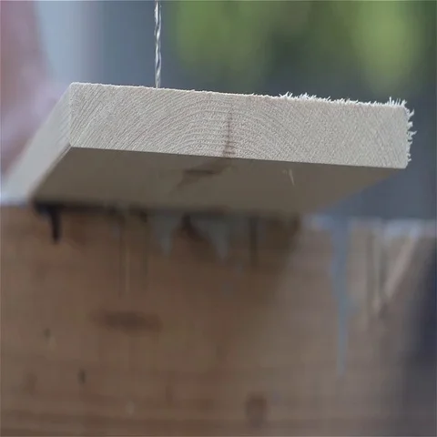 Slow Motion Small drill bit drills into board Lower POV Video stock 69541163