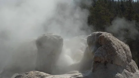 Slow motion small geyser eruption tilt up Stock Footage 79475549