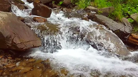 Slow motion of a small mountain waterfall. 240fps. The mountain stream falls Stock Footage 91758215
