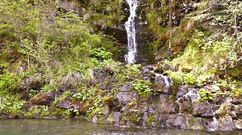 Slow motion. Small waterfall and stream or river  Stockbeeldmateriaal 64590512