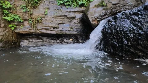 Slow motion small waterfall small mountain river Stock Footage 319879571