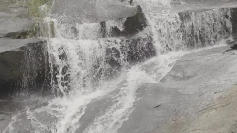 Slow Motion of Small Waterfall/Cascata Flowing Over Rocks in Paraty Stock Footage 320633575