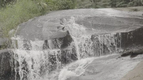 Slow Motion of Small Waterfall/Cascata Flowing Over Rocks in Paraty Stock Footage 320633576