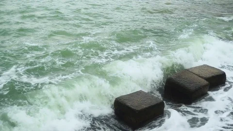 Slow motion a small wave is broken against the square stones Stock Footage 82126029