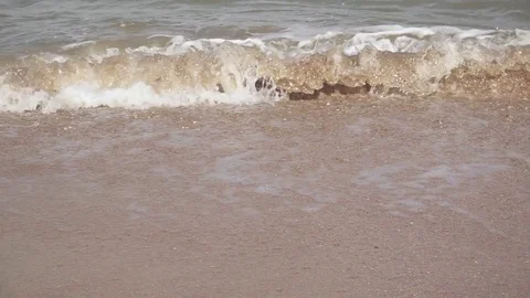 Slow motion small waves on a sandy beach Stock Footage 81352008