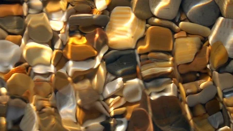 Slow motion of small waves on shallow pure water with shingle bottom close up. Stock Footage 98094961