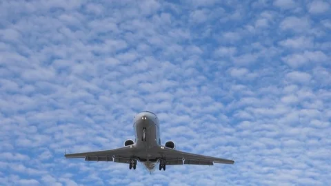 Slow motion. Small white private jet flies overhead. Final approach. Toronto. Video stock 80852327