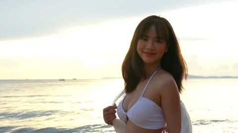 SLOW MOTION: Smiling attractive young asian woman bikini sexy with shawl on a se Stock-Footage 199567819