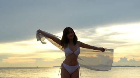 SLOW MOTION: Smiling attractive young asian woman bikini sexy with shawl on a se Stock Footage 199569476