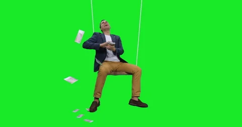 Slow motion of smiling man scattering euro cash sitting on rope swing Stock Footage 269003848