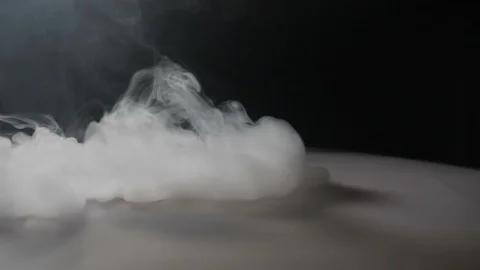 Slow motion smoke as an abstract background coming in waves from someone who  Stock Footage 87730790