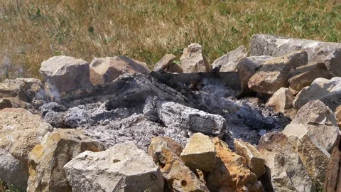 Slow motion Smoke and ash campfire, made with wood and rocks. Stock Footage 113075744