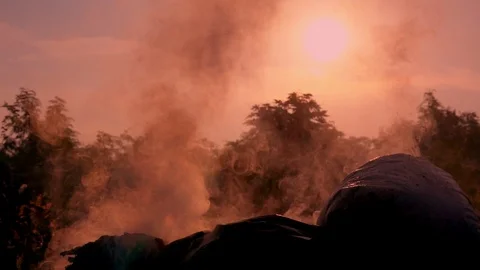 Slow motion smoke of fire burning garbage on dark background, White smoke Video stock 89945854