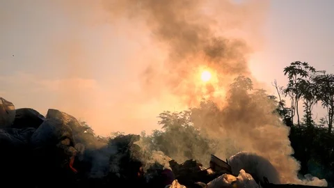 Slow motion smoke of fire burning garbage on dark background, White smoke Stock Footage 89946678