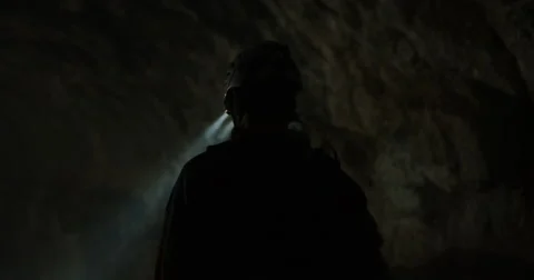 Slow motion in a smoky cave of two explorers shinning headlamps Stock Footage 64684224