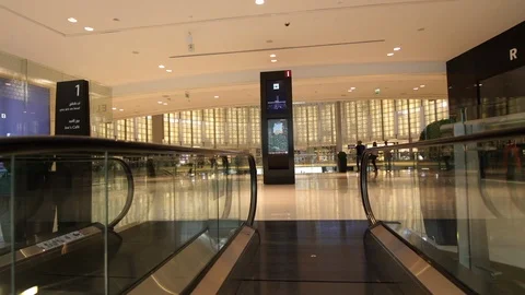 Slow motion smooth shot floating up from an escalator in a shopping mall Stock Footage 109184702
