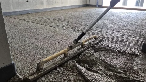 Slow motion of smoothing polystyrene concrete with long-handled screed tool Stock Footage 343755767