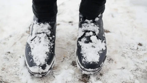 Slow Motion Of Snow Being Cleared Off Of Boots Stock-Footage 85104097