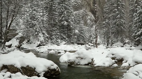 Slow motion snow fall over mountain creek Stock Footage 85701215