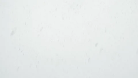 Slow Motion Snow Falling Against a Blank Grey Sky Video stock 133098219