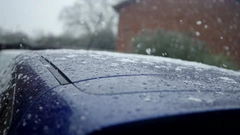 Slow motion snow falling onto car roof (4K 120fps). Stock Footage 145921637