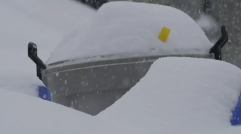 Slow motion snow falling in front of garbage cans and recycling Stock Footage 60411291