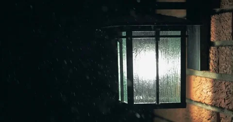 Slow Motion of Snow Falling on Glass House Lamp During Winter Storm Stock Footage