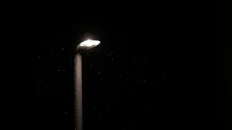 Slow motion snow falling at night street lamp Winter England December 2017 Stock Footage 83313369