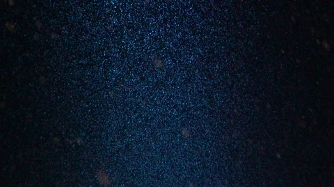 Slow motion of a snow falling at night coloured by a led lamp Stock Footage 87751822