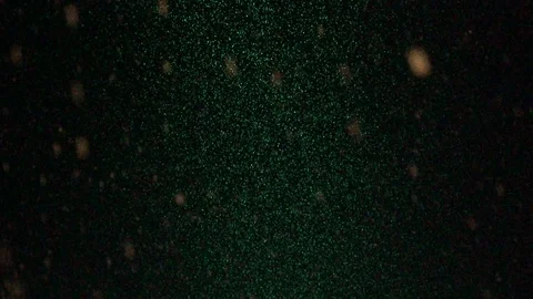 Slow motion of a snow falling at night coloured by a led lamp Stock Footage 87751876