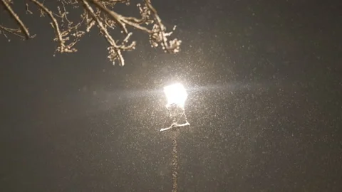 Slow Motion. Snow falling at night lit by a street lamp. Stock Footage 226069580