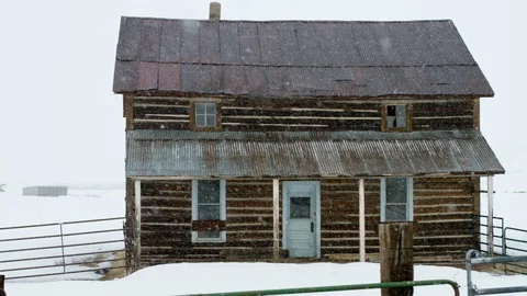 Slow motion snow falling over an old cabin Stock Footage 113265693