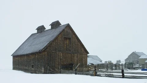 Slow motion snow falling over an old barn Stock Footage 113265916