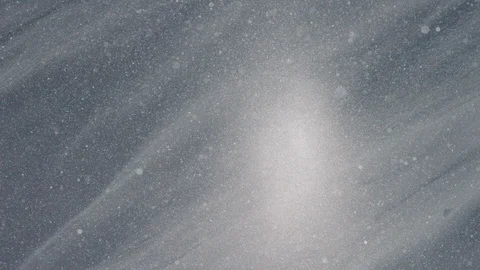 Slow motion snow particles drifting across frame over a snowy slope Stock Footage 113254244