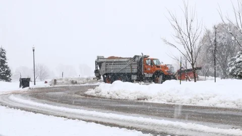 Slow motion of snow plow clearing streets during a snowstorm Stock Footage 112238978