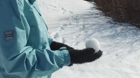 Slow motion snowball ready for throwing Stock Footage 61376421