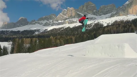 Slow motion of snowboarder jumping backside Stock Footage 64774106