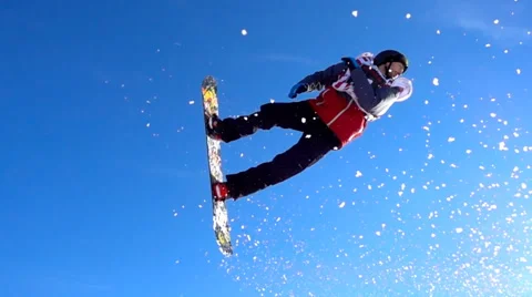 SLOW MOTION: Snowboarder jumping over kicker in sunny winter. Stock Footage 60937766