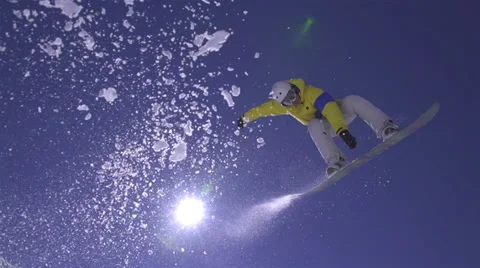 SLOW MOTION: Snowboarder jumps the kicker Stock Footage