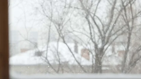 SLOW MOTION: Snowfall in winter - view from window Видео 70572825