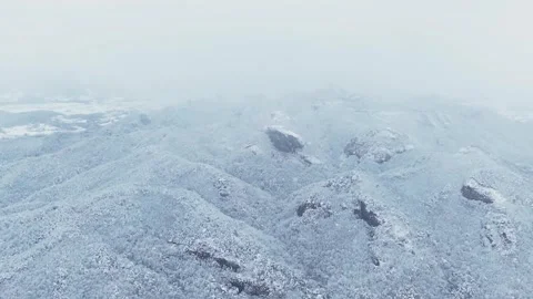 Slow Motion Snowflakes Over a Snow-Covered Mountain Landscape in South Korea Stock Footage 344247802