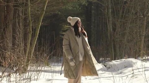 Slow motion. Snowy forest. Beautiful girl goes to the camera. Stock Footage 154209630